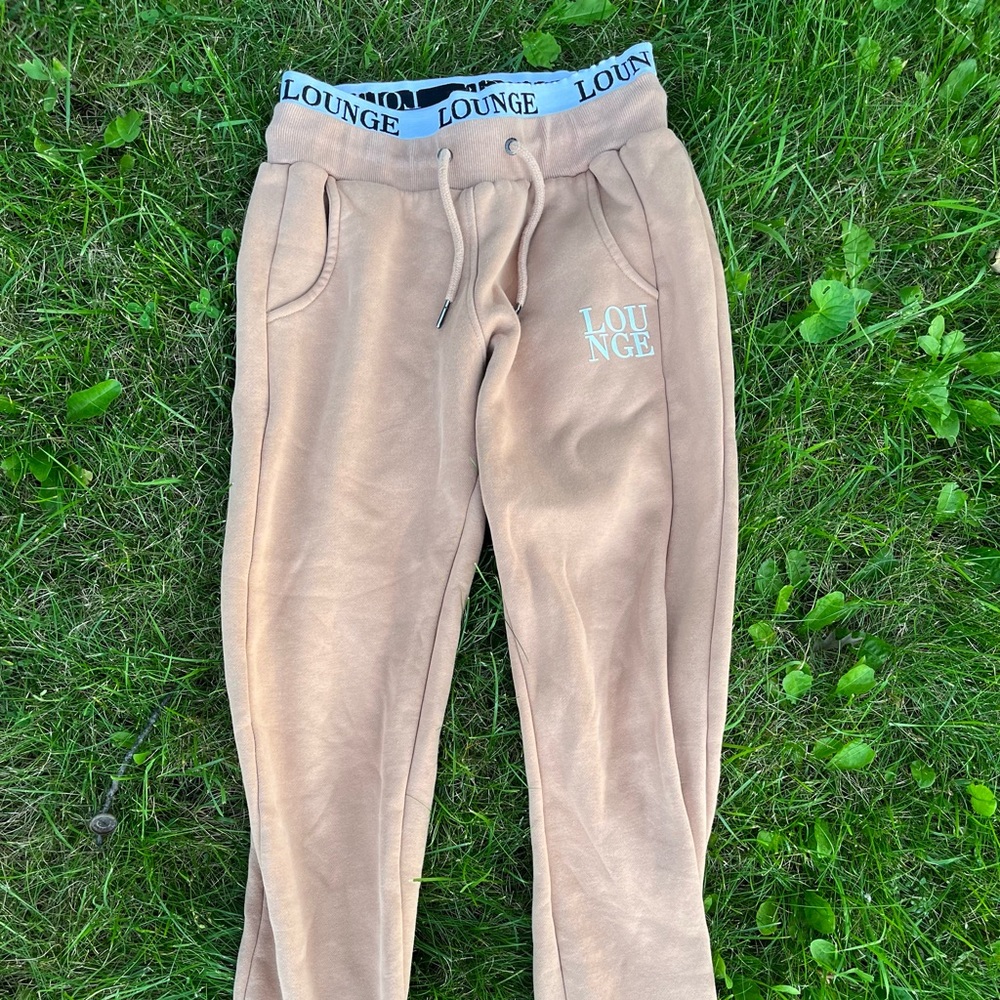 Small tan LOUNGE apparel brand joggers